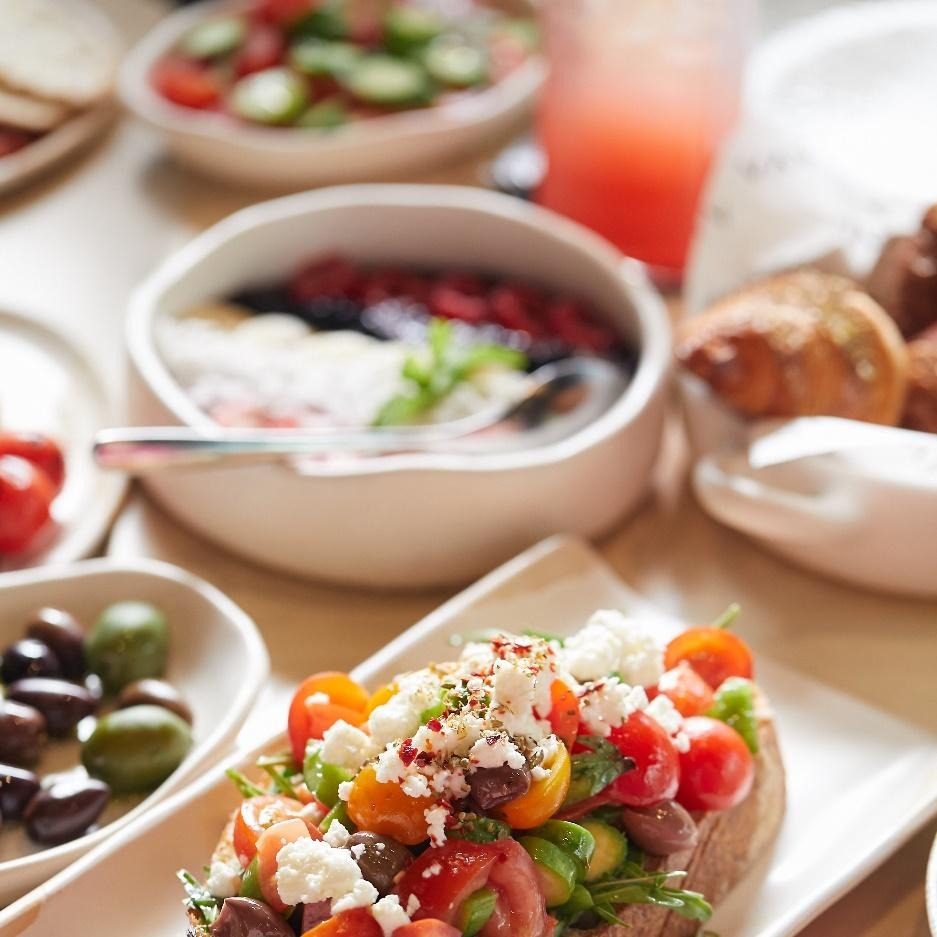 Food on the platter with herbs, cheese, garnishes, and spices 