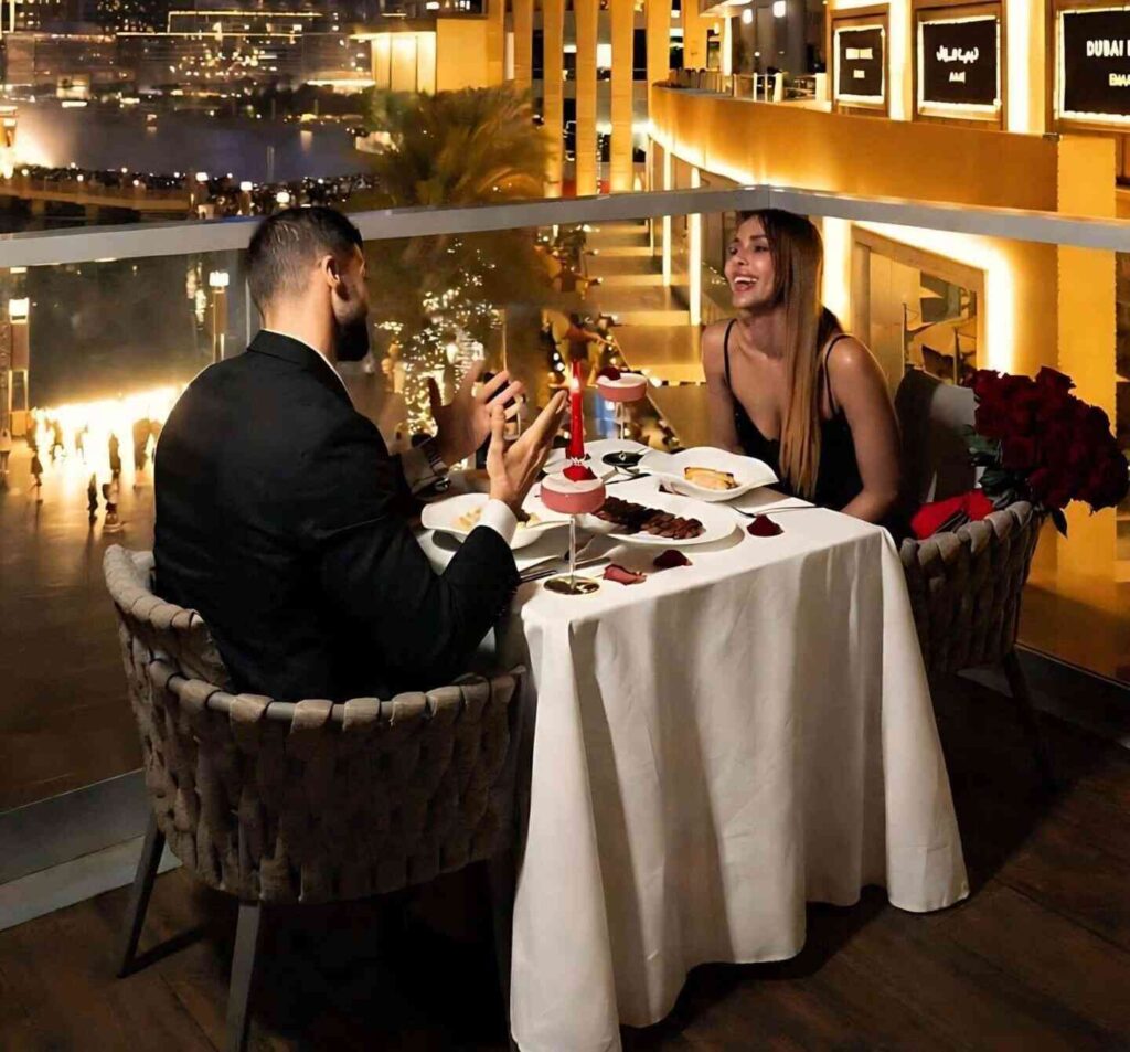 Couple enjoying a romantic rooftop dinner with Dubai city views and candlelit ambiance